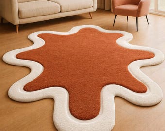 Alfombra moderna de lana con formas orgánicas en tonos óxido y marfil: diseño abstracto