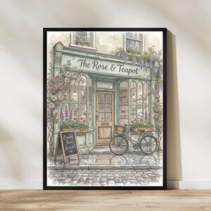 Peut inclure: Une illustration aquarelle encadrée d'une devanture intitulée The Rose & Teapot, avec une façade vert clair, une porte en bois, de grandes vitrines, des rosiers grimpants, un vélo avec un panier et un panneau indiquant Cream Teas Served.