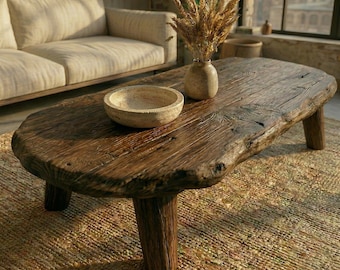 Reclaimed handmade rustic solid wood coffee table with natural, live-edge edges.