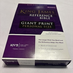 May include: A white ceramic mug with a black handle and the text "But First, Coffee" in a bold, black font. The mug is set against a blurred background, suggesting a cozy setting.