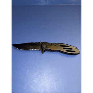 May include: A black folding pocket knife with a partially serrated blade and a handle featuring three horizontal cutouts. The knife is shown in an open position, displaying a metallic finish on the handle and a dark blade with a sharp point.