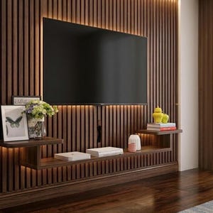 May include: A modern entertainment center with a large black television mounted on a dark wood panel wall. The wall features vertical wooden slats with built-in lighting. Floating shelves display decor, including books, vases, and framed art.