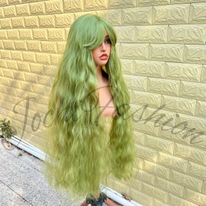 May include: A long, wavy, green wig with a fringe. The wig is displayed on a mannequin head, highlighting its length and texture. The hair is a bright green, with a natural wave pattern. Suitable for cosplay or costume purposes.