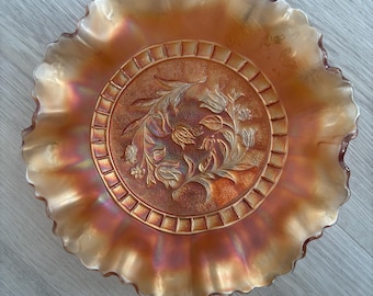 Dugan Windflower Carnival Glass bowl, specifically in the marigold color, produced between 1911 and 1931
