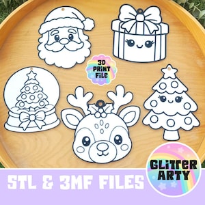 May include: Five white Christmas-themed ornaments with black outlines featuring a Santa Claus, a gift box, a snow globe with a tree, a reindeer, and a Christmas tree. A circular logo in the center reads 3D PRINT FILE, and a bottom logo reads GLITTER ARTY.