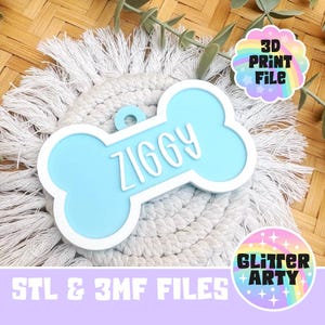 May include: A light blue bone-shaped pet tag with a white border and the name ZIGGY embossed in white lettering. The tag features a small circular hole at the top for attachment. The text 3D PRINT FILE and STL & 3MF FILES are visible.