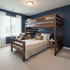 Op de afbeelding: Een houten stapelbed met een tweepersoonsbed beneden en een eenpersoonsbed boven. De kamer heeft marineblauwe muren, witte gordijnen en een lichtgekleurd tapijt. Een klein bijzettafeltje en een gitaarkoffer staan naast het bed.