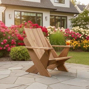 May include: Wooden Adirondack chair with a side table, set on a stone patio. The chair is made of light brown wood and is positioned in front of a vibrant flower garden with red, white, and yellow blooms. A glass of iced tea sits on the side table.