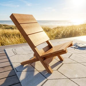 May include: A low-profile wooden lounge chair featuring a slanted backrest and a seat constructed from horizontal planks. The chair has a natural light brown wood grain finish and a simple, angular frame design with intersecting support legs.