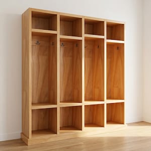 May include: A light-colored wooden storage unit with multiple compartments. The unit has open shelves and hooks for hanging items. The design is simple and modern, suitable for entryways or mudrooms. The unit is made of light-colored wood.