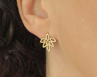 May include: Gold earrings with a delicate floral design. The earrings are made of a thin metal and have a delicate, intricate design.