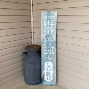 May include: A wooden sign with a blue and white distressed paint finish. The sign reads "As for me and my house we will serve the Lord. Joshua 24:15"