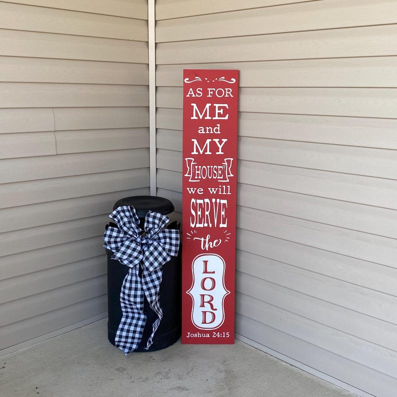 May include: Red wooden sign with white text that reads "As for me and my house we will serve the Lord, Joshua 24:15".