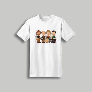 May include: White t-shirt featuring a cartoon band with four members playing instruments. The band includes a guitarist, a drummer, a bassist, and a keyboardist. The illustration is in a simple, cartoon style.