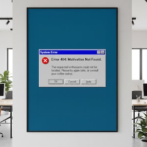 May include: A framed print with a blue background and a simulated computer error message. The message reads "Error 404: Motivation Not Found." with options to "OK", "Cancel", and "Help". The print is displayed in an office setting.