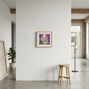 May include: A square framed art print featuring a vibrant, colorful illustration of a room interior with pink and purple walls, a central chandelier, and scattered objects, displayed in a light wood frame on a white textured wall.