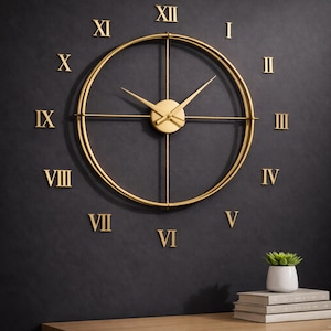 May include: A gold-colored, modern wall clock with Roman numerals. The clock features a circular design with a minimalist aesthetic. The hands and numerals are in a matching gold tone, set against a dark gray wall. A small plant and books sit below.