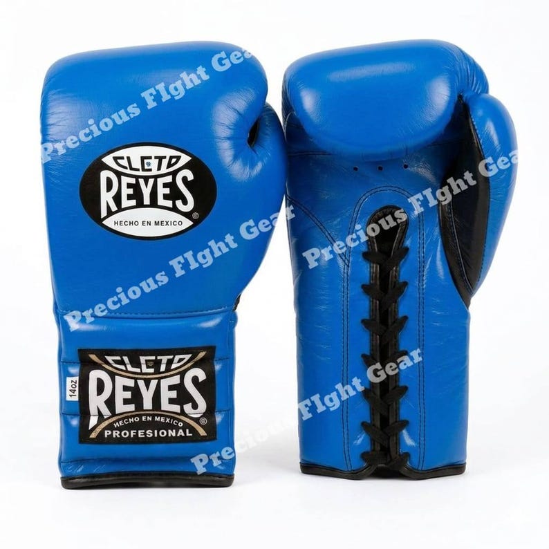 May include: A pair of bright blue boxing gloves featuring the Cleto Reyes logo on the front and a black lace-up closure system. The left glove displays a label indicating 14oz weight, and both gloves are marked with the text Hecho en Mexico.