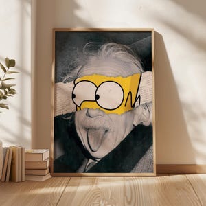 May include: Framed art print showing a black and white portrait of Albert Einstein with a yellow Bart Simpson mask over his eyes. The mask is torn, revealing text. The artwork is in a wooden frame.