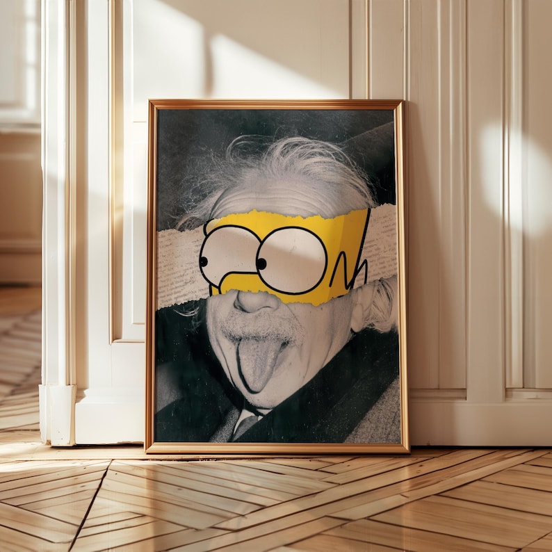 May include: Framed art print showing a black and white image of Albert Einstein with a yellow cartoon eye mask. The mask has black outlines and the word "ON" is visible. The print is in a gold frame.