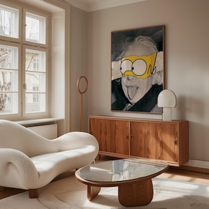 May include: A living room interior with a framed artwork depicting Albert Einstein with cartoon eyes. The room includes a wooden cabinet, a white lamp, a modern white sofa, and a wooden coffee table with a glass top. The room has a neutral colour palette.