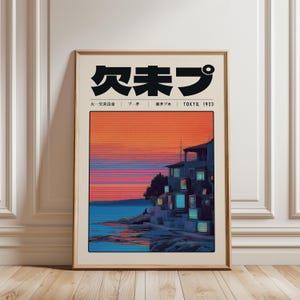 May include: Framed art print featuring Japanese text and a coastal scene. The artwork depicts a building with illuminated windows against a vibrant sunset sky. The print includes the text "TOKYO, 1923" and Japanese characters.