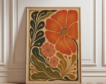 May include: A rectangular framed wall art print featuring a large orange flower and two smaller pink flowers. The design includes dark green and mustard yellow stylized leaves and stems on a light beige background, all enclosed in a light wood frame.