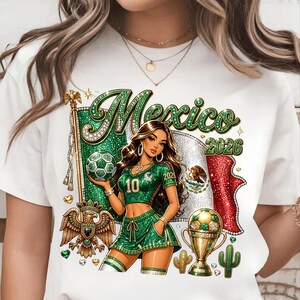 May include: A white t-shirt featuring a graphic of a person in a green soccer uniform holding a soccer ball. The design includes the text "Mexico" and "2026," a Mexican flag, a golden eagle emblem, a trophy filled with soccer balls, and cacti.