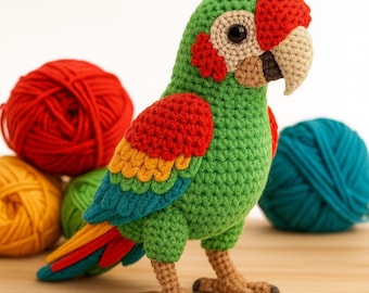 May include: A handmade crochet parrot in vibrant green, red, yellow, and blue. The bird has a tan beak and feet, with a red head and accents. Colorful yarn balls in red, yellow, green, and teal are in the background. A whimsical, decorative item.