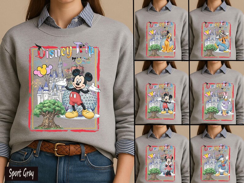 May include: A sport gray crewneck sweatshirt featuring a graphic print with the text Disney Trip, a castle, a large tree, and Mickey Mouse. The design includes colorful balloons and a geodesic sphere. Additional variations show Pluto, Goofy, Daisy, Minnie, and Donald.