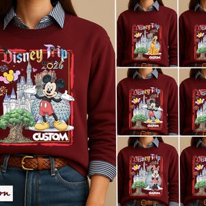 May include: A maroon crewneck sweatshirt featuring a graphic print with the text Disney Trip 2026. The design includes a castle, a large spherical structure, a tree, fireworks, and various Disney characters like Mickey Mouse, Pluto, and Donald Duck.