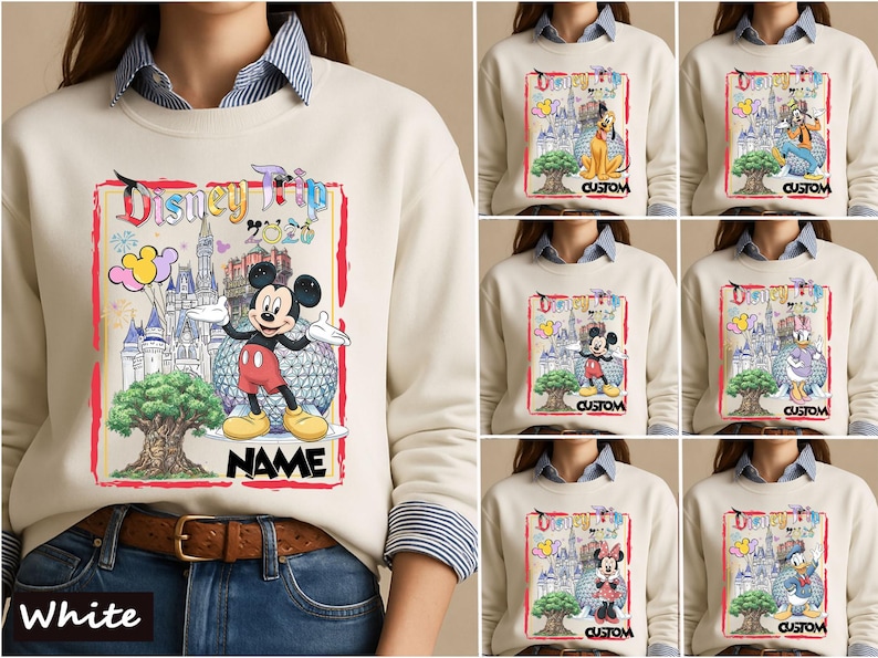 May include: A cream-colored crewneck sweatshirt featuring a graphic print with the text Disney Trip 2020, a castle, a large tree, and various Disney characters including Mickey Mouse, Pluto, Goofy, Donald Duck, Daisy Duck, and Minnie Mouse.