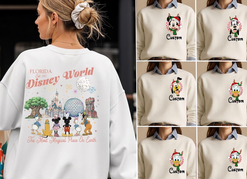 May include: A white crewneck sweatshirt featuring a large back graphic of Disney World landmarks and characters with the text Florida Est. 1971 Disney World The Most Magical Place on Earth. The front features a small circular character print and Custom text.