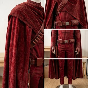 May include: A deep red textured costume featuring a long cape, a matching long-sleeved top, and trousers. The outfit includes a brown leather utility belt with pouches, a shoulder strap with cylindrical loops, and matching brown leather gloves.