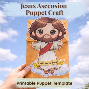 May include: A printable puppet craft featuring a cartoon Jesus figure with brown hair and a beard, wearing a white robe and red sash. The puppet is on a brown paper bag with the text "Jesus Ascension Puppet Craft" and "I will come back!"