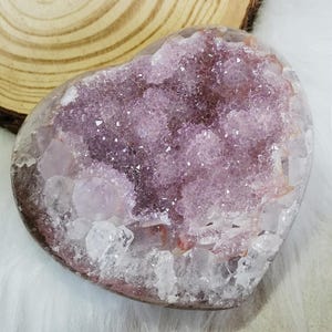 May include: A set of three ceramic mugs with a speckled, matte finish. The mugs are in shades of cream, light grey, and dark grey. Each mug has a simple, minimalist design and a rounded handle.