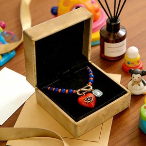 May include: A white ceramic mug with a black handle and the text "But First, Coffee" in a handwritten style. The mug is on a white surface. The mug is 4 inches tall.