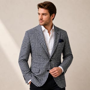 May include: A navy and white plaid blazer with a white dress shirt and a navy pocket square. The blazer has a two-button closure and is worn with black pants. The overall style is classic and tailored.