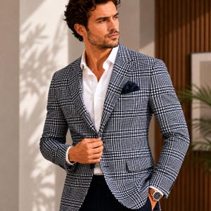 May include: A navy and white plaid blazer with a white dress shirt and a navy pocket square. The blazer has a classic fit and is worn with a gold watch.