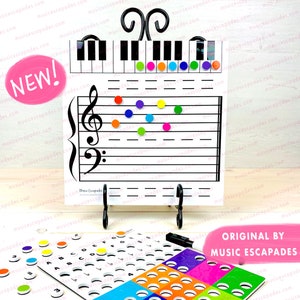 May include: A white magnetic music learning chart with a treble clef, five lines, and a piano keyboard. The chart has colourful magnetic dots on it. There are also colourful magnetic circles with letters and numbers on them.
