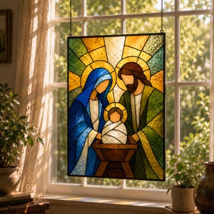 May include: A rectangular stained glass panel depicting a nativity scene with three figures in a manger. The artwork features vibrant blue, green, yellow, and brown glass segments held together by dark metal lines, hanging in a window frame.