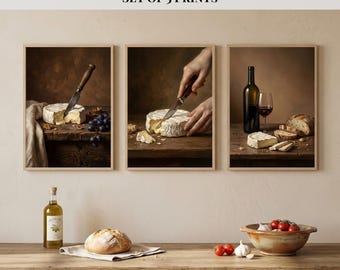 May include: Set of three framed prints titled "Wine & Brie Triptych." Each print features a still life with brie cheese, wine, and bread. One print shows a knife cutting the cheese, another shows a bottle and glass of wine, and the third shows a loaf of bread.
