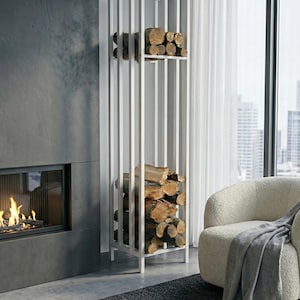 May include: A white, vertical firewood rack filled with stacked logs. The rack has a modern, minimalist design with a series of vertical bars. The logs are brown and arranged neatly within the rack. The rack is placed next to a fireplace.