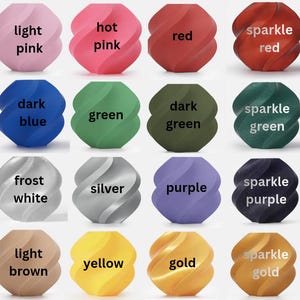 May include: A collection of colorful, spiral-shaped objects, each labeled with a different color name. Colors include orange, pink, red, blue, green, black, white, yellow, and gold. Some have a sparkle effect.