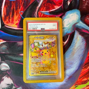 May include: A graded Pok&eacute;mon card featuring Pikachu ex from the 2024 SSP EN Hyper Rare set. The card is encased in a yellow holder and is graded as Mint 9. The card's artwork is predominantly yellow and gold, with the text "Pikachu ex" visible.