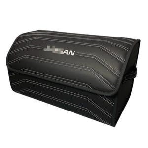 May include: Black storage container with white stitching and the text "AN". The container has a rectangular shape with a curved top and a handle on the side. The stitching creates a geometric pattern.