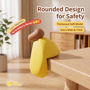 May include: A yellow and brown corner protector, shaped like a banana, is attached to a wooden table. The text on the image says "Rounded Design for Safety" and "Care Anytime, Say Goodbye to Bumps GO!!". The product is described as "Thickened Soft Shield" and "Extra Wide & Thick".
