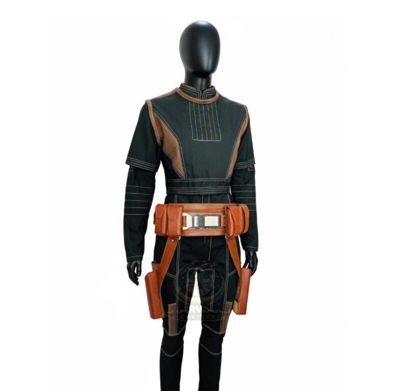 May include: A black long-sleeved tunic and pants set featuring white topstitching, brown textured shoulder panels, and a brown utility belt with multiple pouches and a central metallic buckle, worn on a black mannequin display form.