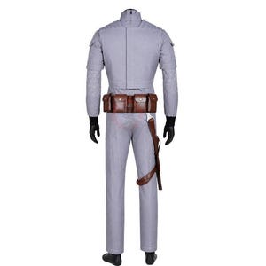 May include: A light grey long-sleeved jumpsuit featuring quilted shoulder and sleeve detailing, a high collar, and black gloves. A brown leather utility belt with multiple pouches and a holster is worn around the waist over the jumpsuit.