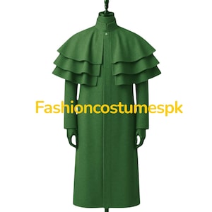 May include: A long, green coat with a layered cape detail and matching gloves. The coat is displayed on a mannequin. The text "Fashioncostumespk" is printed in yellow on the coat.